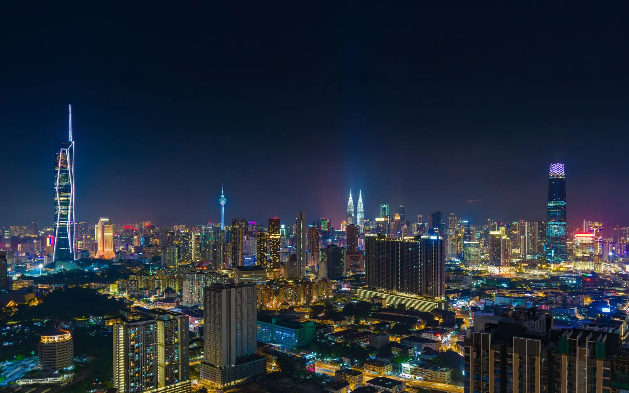 The Kuala Lumpur skyline at night — home of Millennium Motors, authorised DENZA dealer